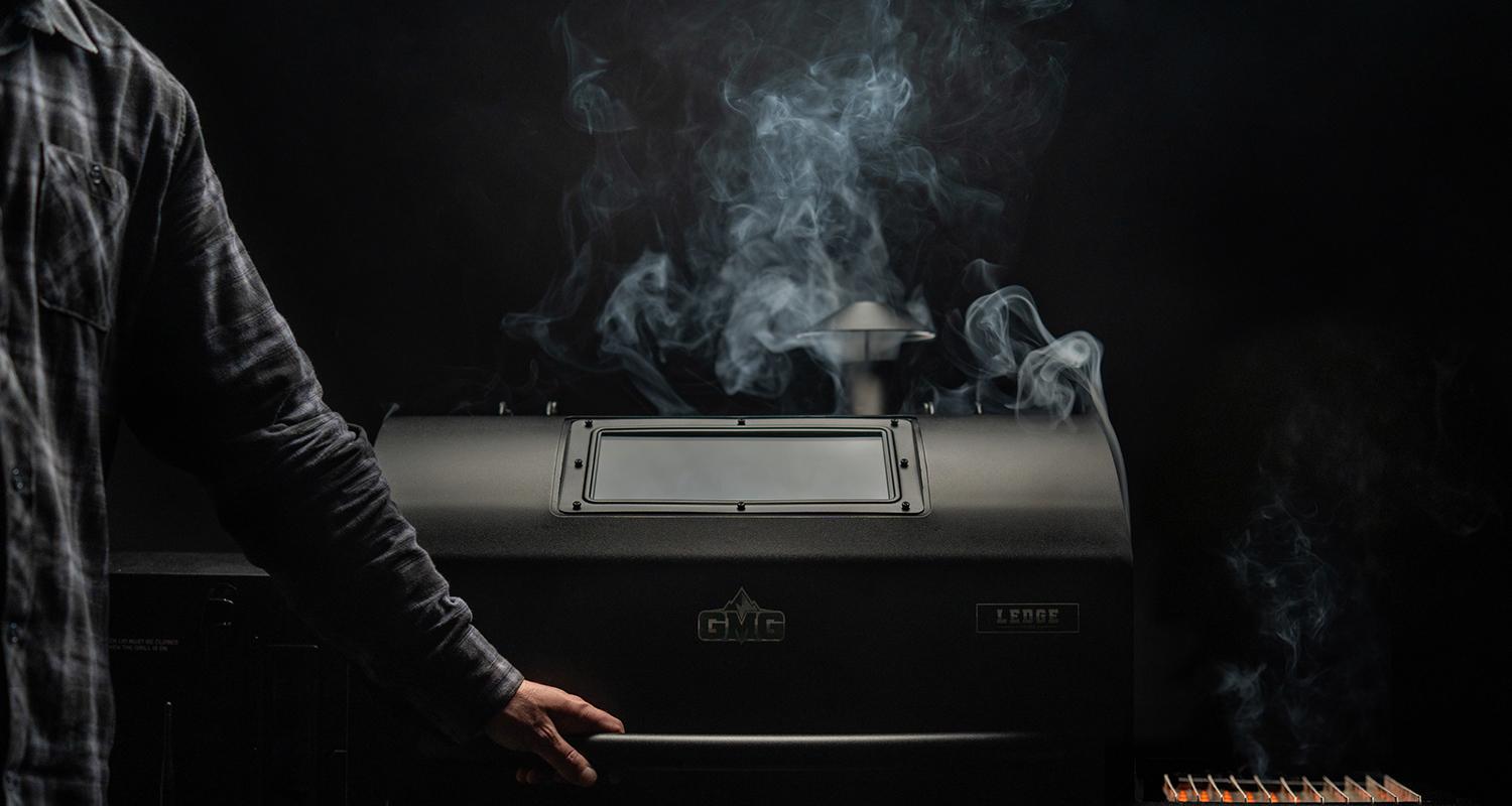 A man Infront of a grill that is the future of BBQ - prime 2.0